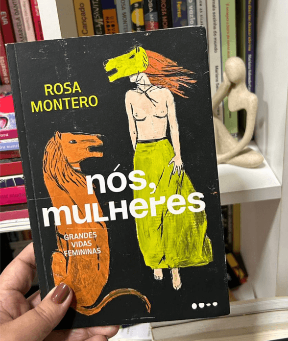 A copy of Rosa Montero's nós, mulheres held up in front of a bookshelf