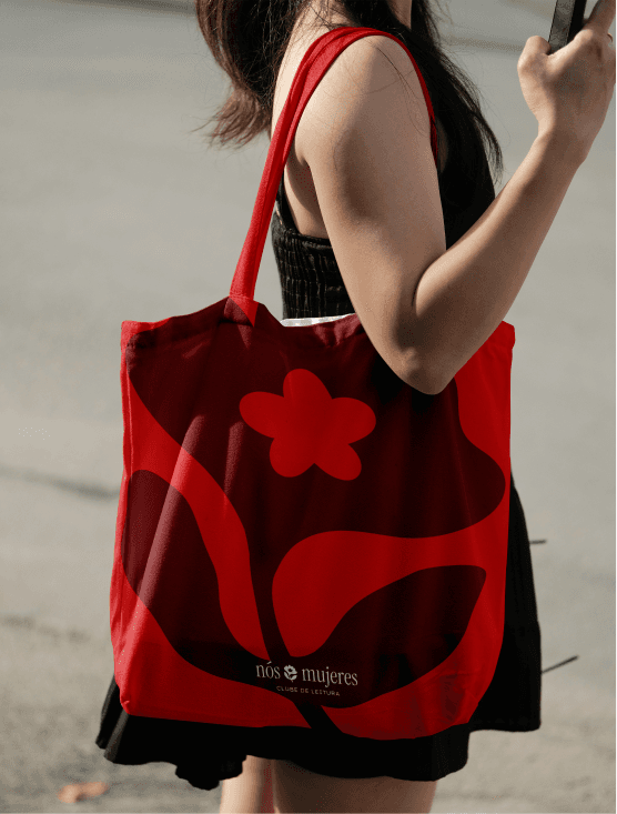 The club's red tote bag printed with the brand flower