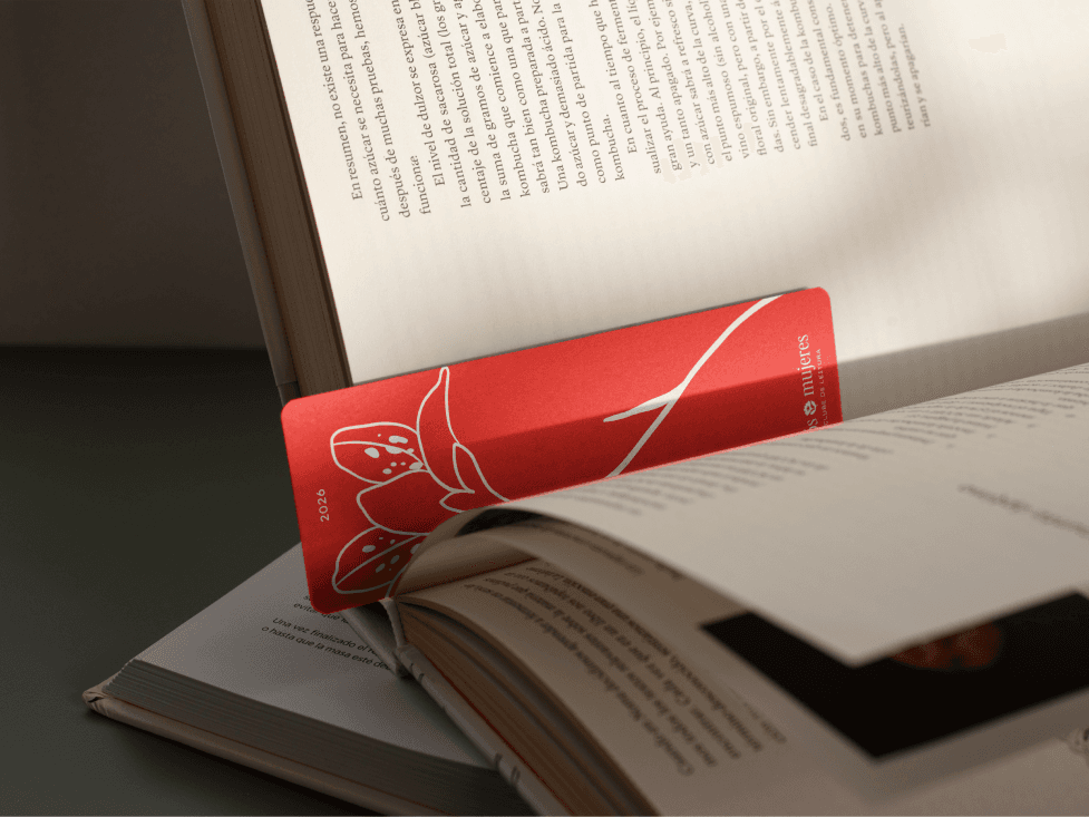 A red bookmark holding the page of an open book