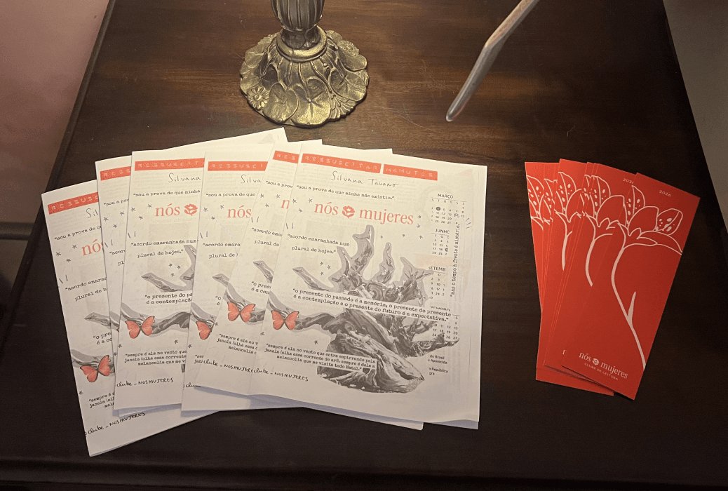 Club zines and bookmarks spread out on a wooden table